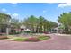 Beautiful fountain surrounded by flowers, palm trees, and storefronts in a charming town center setting at 4709 Fox St, Orlando, FL 32814
