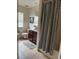 Well-maintained bathroom with a vanity, toilet, and shower featuring a striped curtain at 5040 Rock Rose Loop, Sanford, FL 32771