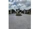 Elegant gated community entrance with brick paved road, decorative pillars, and a lush central median at 5040 Rock Rose Loop, Sanford, FL 32771