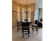 Cozy dining area with a round table and chairs illuminated by a modern chandelier at 5040 Rock Rose Loop, Sanford, FL 32771