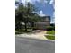 Home with a two-car garage, green lawn and large trees in a suburban neighborhood at 5040 Rock Rose Loop, Sanford, FL 32771