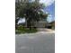 Home with a two-car garage, green lawn and large trees in a suburban neighborhood at 5040 Rock Rose Loop, Sanford, FL 32771