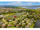 Areal view of homes in a community near a lake with mature trees and marshlands at 5306 Crane Hill Ct, St Cloud, FL 34771