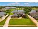 Spacious landscaped front yard and long driveway leading to a well-maintained home near water at 5306 Crane Hill Ct, St Cloud, FL 34771