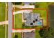 An aerial view of the backyard of a home, featuring solar panels and a screened pool at 5306 Crane Hill Ct, St Cloud, FL 34771