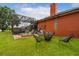 Beautiful backyard with screened-in pool, fire pit, and lush green lawn, ideal for outdoor entertaining at 5306 Crane Hill Ct, St Cloud, FL 34771