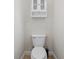 Small water closet featuring a standard white toilet, cabinet, and painted walls at 5306 Crane Hill Ct, St Cloud, FL 34771