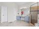 Bright bathroom featuring tile floors, glass shower, and blue cabinets with large mirror at 5306 Crane Hill Ct, St Cloud, FL 34771