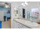 Double vanity bathroom with large mirror, stylish fixtures, and access to adjacent rooms at 5306 Crane Hill Ct, St Cloud, FL 34771