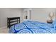 Bedroom features a blue patterned bedspread, side table with lamp, and black console table at 5306 Crane Hill Ct, St Cloud, FL 34771