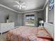 Comfortable bedroom showcasing neutral walls, white trim, ceiling fan, and pool view at 5306 Crane Hill Ct, St Cloud, FL 34771