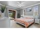 Comfortable bedroom with sliding glass door, neutral walls, white trim, and ceiling fan at 5306 Crane Hill Ct, St Cloud, FL 34771