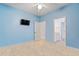 Tiled bedroom featuring an open doorway and a mounted TV, ideal for relaxation and entertainment at 5306 Crane Hill Ct, St Cloud, FL 34771
