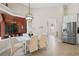 Bright dining area boasting modern lighting, tile floors, and seamless connection to kitchen and outdoor patio at 5306 Crane Hill Ct, St Cloud, FL 34771
