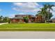 Charming one-story home with well-manicured lawn, mature palm trees, and vibrant landscaping at 5306 Crane Hill Ct, St Cloud, FL 34771
