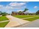 Picturesque single story home showcasing lush landscaping, mature palm trees, and a spacious driveway at 5306 Crane Hill Ct, St Cloud, FL 34771