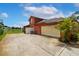 The house features an attached garage and a side yard overlooking a tranquil pond, perfect for relaxation at 5306 Crane Hill Ct, St Cloud, FL 34771