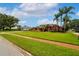 A charming single story home with well-manicured landscaping and mature palm trees on a sunny day at 5306 Crane Hill Ct, St Cloud, FL 34771