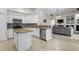 Well-lit kitchen equipped with stainless steel appliances, granite countertops, and center island at 5306 Crane Hill Ct, St Cloud, FL 34771
