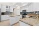 Well-lit kitchen with white cabinets, granite countertops, island, and tile backsplash at 5306 Crane Hill Ct, St Cloud, FL 34771
