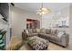 Comfortable living room with tile floors, large sectional, ceiling fan, and fireplace at 5306 Crane Hill Ct, St Cloud, FL 34771