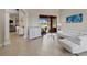 Bright and airy living room features stylish furniture, tile flooring, and seamless access to outdoor patio at 5306 Crane Hill Ct, St Cloud, FL 34771