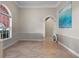 Inviting living room with arched doorway, elegant wainscoting, and abundant natural light at 5306 Crane Hill Ct, St Cloud, FL 34771