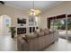 Spacious living room filled with natural light, features a fireplace and sliding glass doors to the pool area at 5306 Crane Hill Ct, St Cloud, FL 34771