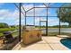 Outdoor kitchen and seating area near the pool provide the perfect space for relaxation at 5306 Crane Hill Ct, St Cloud, FL 34771