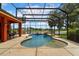 Screened-in pool with a rock waterfall feature and a view of the lake at 5306 Crane Hill Ct, St Cloud, FL 34771