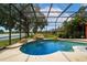 Private screened-in pool with scenic lake view and stone waterfall at 5306 Crane Hill Ct, St Cloud, FL 34771