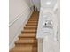 Carpeted staircase leading to the second floor with white railing and views of the kitchen at 5306 Crane Hill Ct, St Cloud, FL 34771
