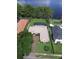 Aerial view of a home featuring a well-maintained landscape, screened pool and private lake access at 5416 Bay Side Dr, Orlando, FL 32819