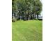 Lush backyard showcasing a beautiful lake view surrounded by mature trees at 5416 Bay Side Dr, Orlando, FL 32819