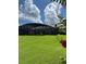 Expansive backyard featuring lush lawn, mature landscaping and screened in porch at 5416 Bay Side Dr, Orlando, FL 32819