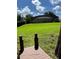 Spacious backyard leading to a wooden dock and lake, enhanced by a screened-in patio at 5416 Bay Side Dr, Orlando, FL 32819