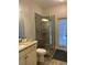 Bathroom featuring granite countertop vanity, toilet, and glass-enclosed walk-in shower at 5416 Bay Side Dr, Orlando, FL 32819