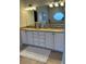 Bathroom featuring a double vanity with granite countertops and a large mirror at 5416 Bay Side Dr, Orlando, FL 32819