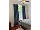 Bedroom featuring hard wood flooring, a ceiling fan, and a large window at 5416 Bay Side Dr, Orlando, FL 32819