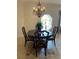 Classic dining room with an elegant chandelier and table set by a sunlit window at 5416 Bay Side Dr, Orlando, FL 32819