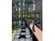 Wooden dock with a covered boat lift and floating dock surrounded by cypress trees and lily pads on the lake at 5416 Bay Side Dr, Orlando, FL 32819
