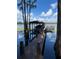 Scenic view of a dock with a covered boat lift and sitting area, nestled on a tranquil lake at 5416 Bay Side Dr, Orlando, FL 32819