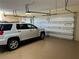 View of a spacious garage with a white vehicle and new insulated garage doors at 5416 Bay Side Dr, Orlando, FL 32819