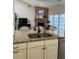 Kitchen featuring a large island with granite countertops and a double sink, looking into the Gathering room at 5416 Bay Side Dr, Orlando, FL 32819