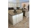 Spacious kitchen with a large island, granite countertops, white cabinets, and stainless steel appliances at 5416 Bay Side Dr, Orlando, FL 32819