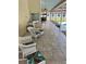 Covered lanai area with patio chairs, tile flooring, and view of the pool and backyard at 5416 Bay Side Dr, Orlando, FL 32819