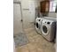 Well-equipped laundry room featuring a side-by-side washer and dryer and tiled floors at 5416 Bay Side Dr, Orlando, FL 32819