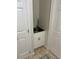 A laundry room corner sink with white cabinets and a tiled floor at 5416 Bay Side Dr, Orlando, FL 32819