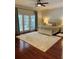 Beautifully furnished bedroom with hardwood floors, ceiling fan, and direct access to the lanai at 5416 Bay Side Dr, Orlando, FL 32819