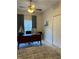 A bright office space with a desk, ceiling fan, large window, and neutral walls at 5416 Bay Side Dr, Orlando, FL 32819